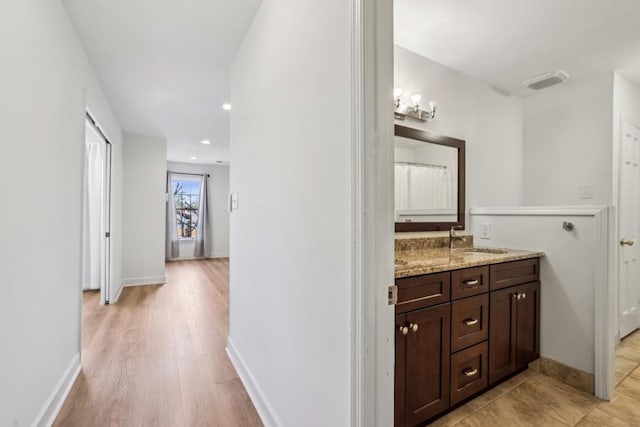 bathroom with vanity and hardwood / wood-style flooring