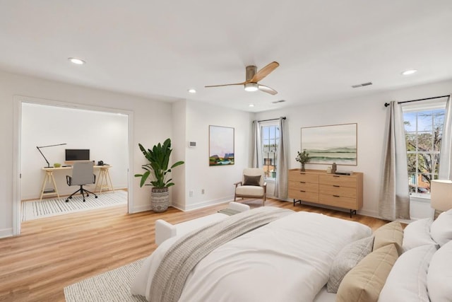 bedroom with ceiling fan and light hardwood / wood-style floors