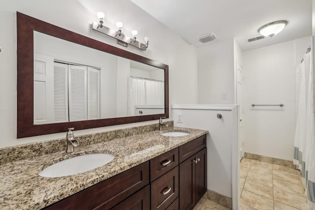 bathroom with vanity and tile patterned flooring