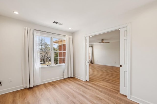 spare room featuring ceiling fan and light hardwood / wood-style flooring