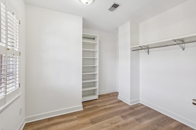 spacious closet featuring hardwood / wood-style flooring