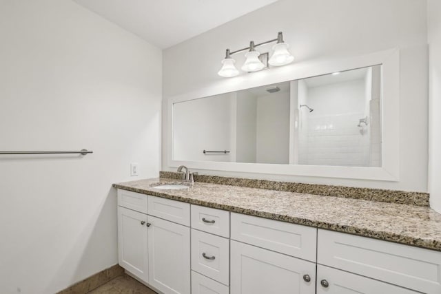 bathroom with walk in shower and vanity