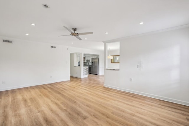 unfurnished living room featuring crown molding, light hardwood / wood-style floors, and ceiling fan