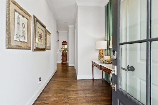 corridor featuring dark wood-type flooring and crown molding