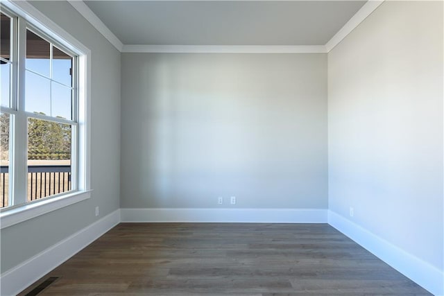 empty room featuring visible vents, crown molding, baseboards, and dark wood-type flooring