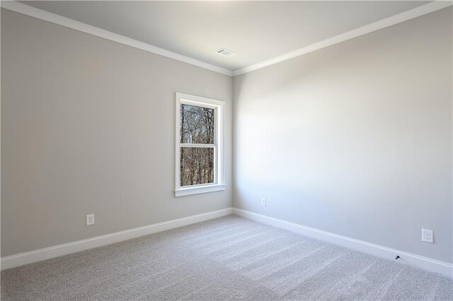 carpeted empty room featuring crown molding, baseboards, and visible vents