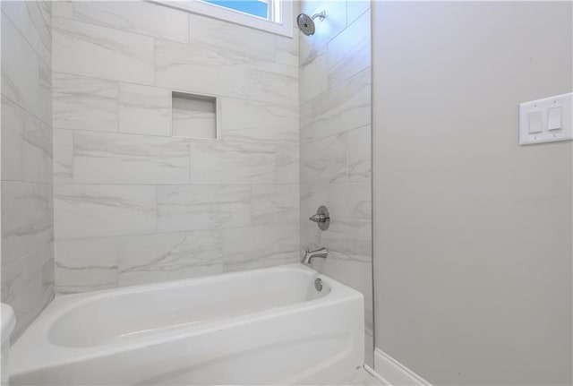 full bathroom featuring baseboards and shower / bath combination