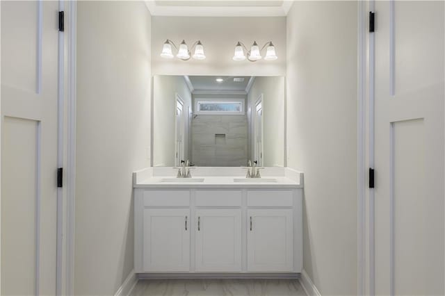 full bath featuring marble finish floor, a sink, and ornamental molding