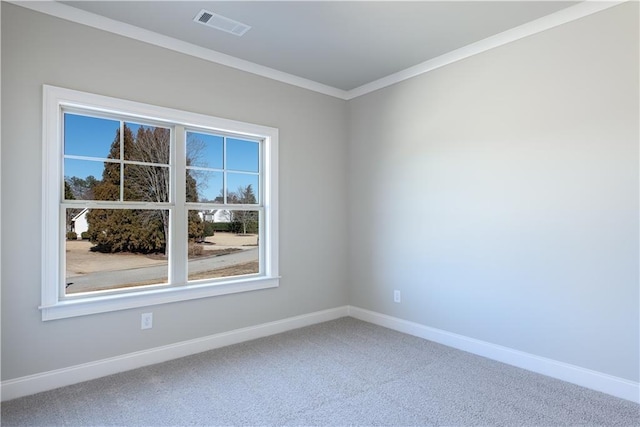 carpeted empty room featuring baseboards, ornamental molding, and visible vents