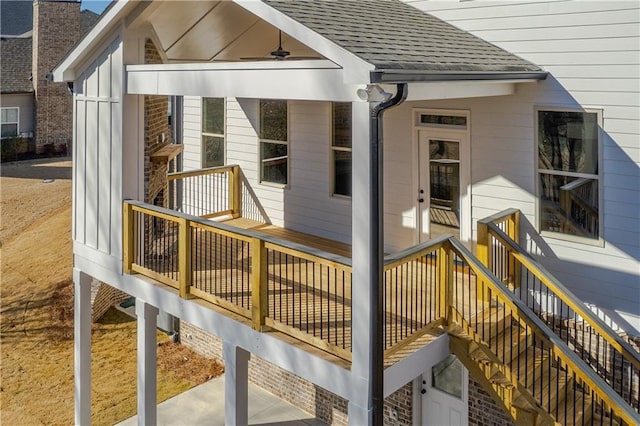 wooden terrace with stairs and a ceiling fan