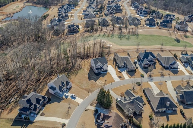 birds eye view of property with a residential view, golf course view, and a water view