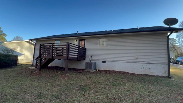 back of house with a yard, a deck, and central AC unit