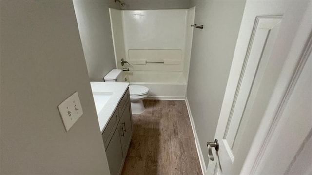 full bathroom featuring vanity, toilet, wood-type flooring, and shower / washtub combination