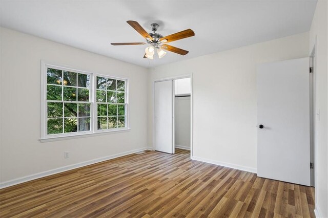 kitchen with oven, a fireplace, light hardwood / wood-style flooring, stainless steel gas cooktop, and white cabinets