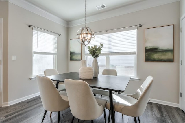 dining space with crown molding, dark hardwood / wood-style floors, and a notable chandelier