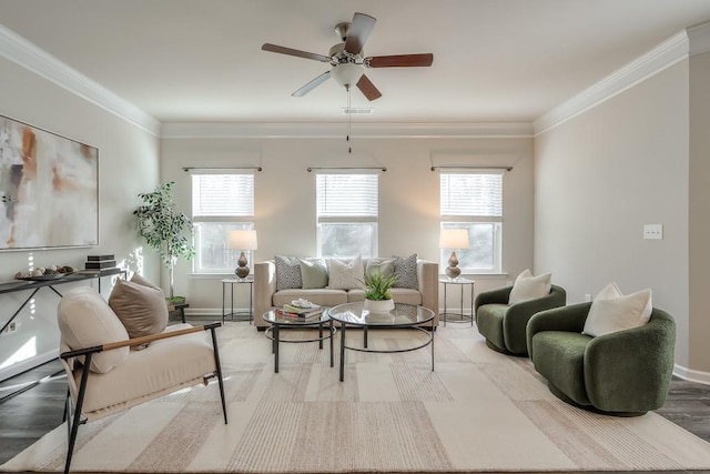 sitting room with plenty of natural light, ornamental molding, and ceiling fan