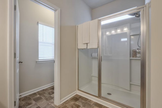 bathroom featuring plenty of natural light and a shower with shower door