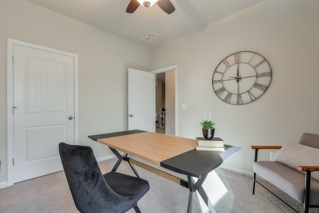 carpeted home office with ceiling fan