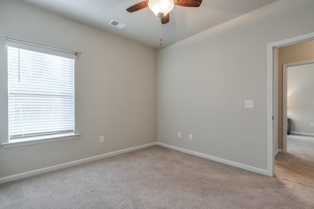 unfurnished room with light carpet and ceiling fan