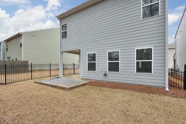 rear view of property with a patio area and a lawn