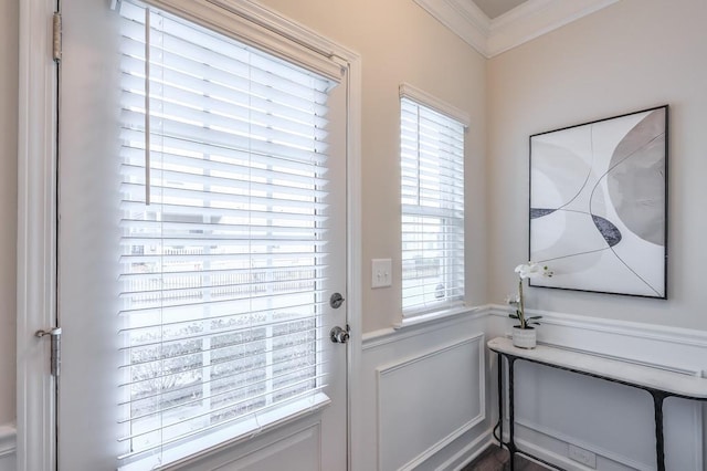 doorway featuring ornamental molding and a healthy amount of sunlight