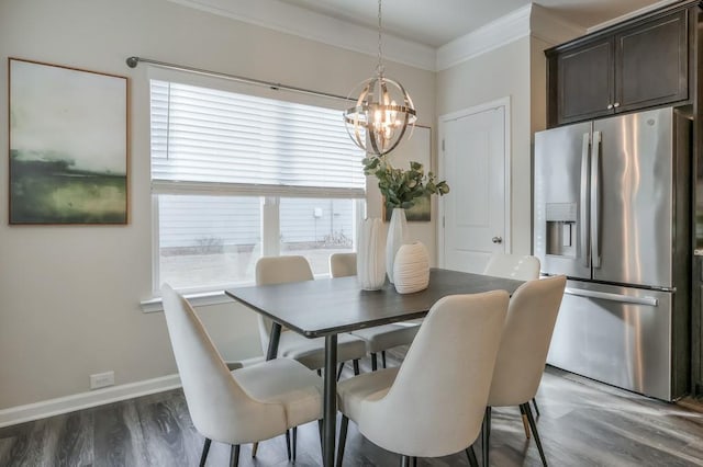 dining room with a notable chandelier, dark wood-type flooring, and ornamental molding