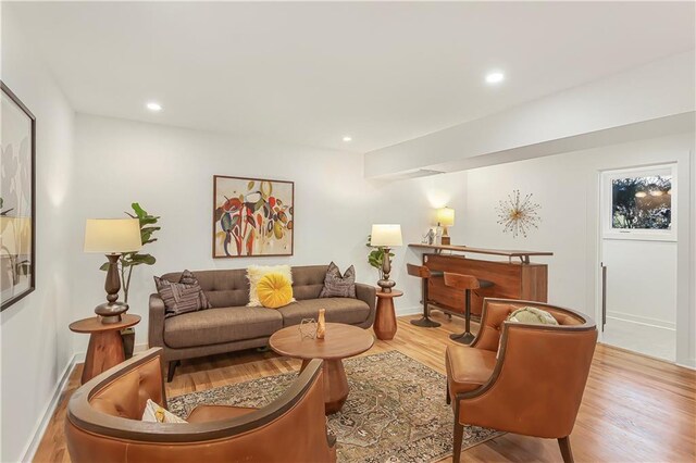 living room featuring recessed lighting, baseboards, and wood finished floors