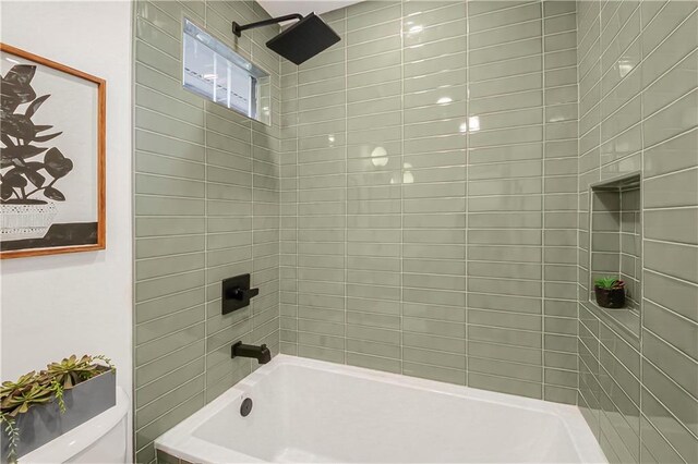 bathroom featuring shower / bathtub combination and toilet