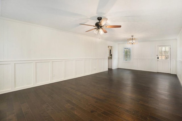 empty room with a wainscoted wall, a decorative wall, ceiling fan with notable chandelier, and hardwood / wood-style floors