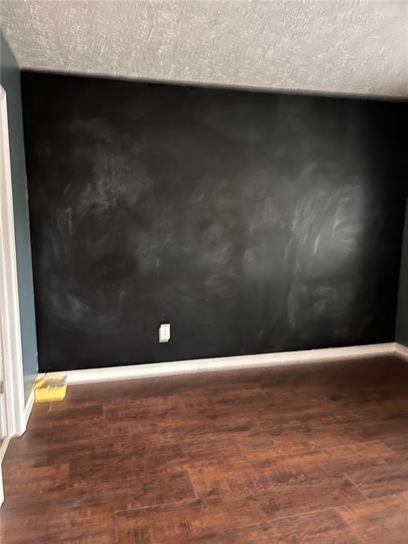 room details with hardwood / wood-style flooring and a textured ceiling