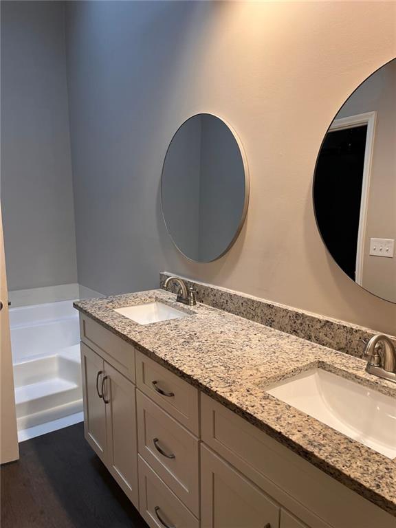 bathroom featuring vanity, toilet, wood-type flooring, and a textured ceiling