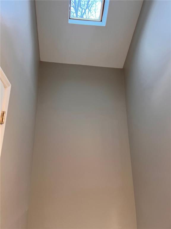 empty room with dark colored carpet and a textured ceiling