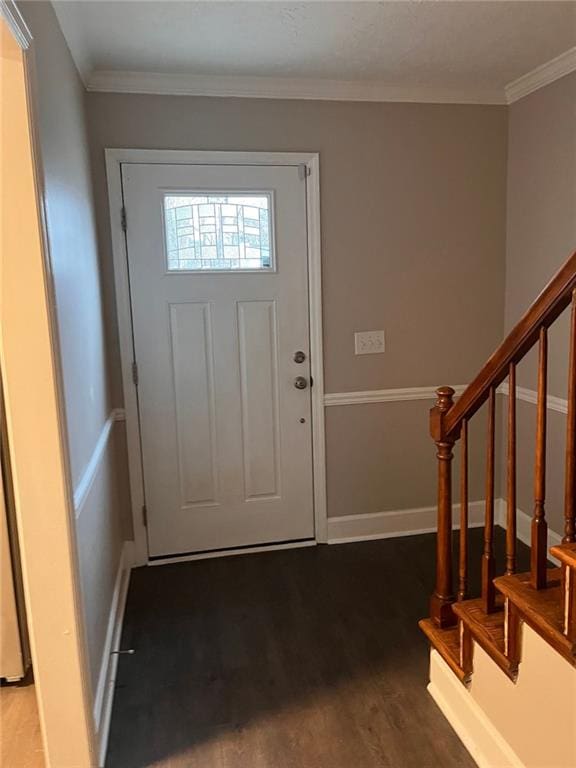 entryway with ornamental molding and dark hardwood / wood-style flooring