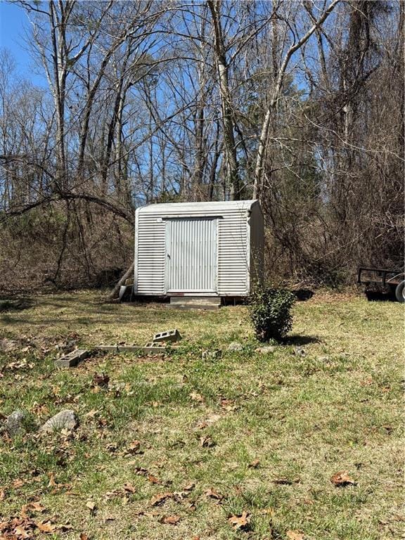 exterior space with a storage shed, central air condition unit, and an outdoor structure