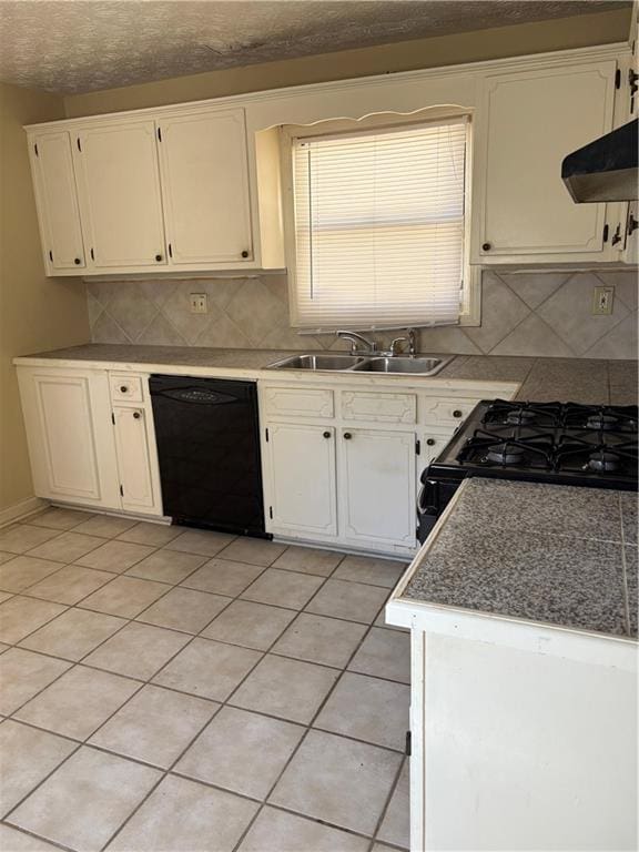 kitchen with light tile patterned floors, a sink, black appliances, white cabinets, and under cabinet range hood