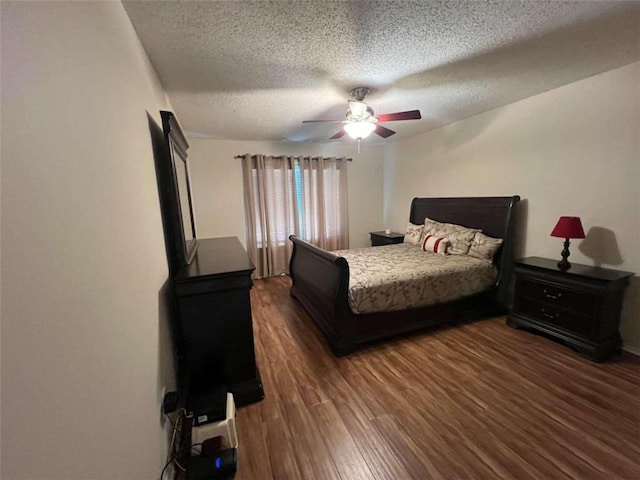 bedroom featuring ceiling fan, a textured ceiling, and dark hardwood / wood-style flooring