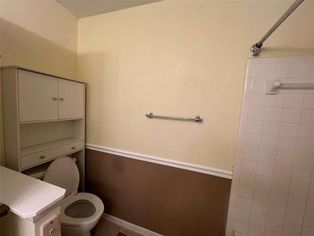 bathroom with a textured ceiling and toilet