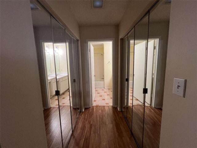 hallway with hardwood / wood-style flooring