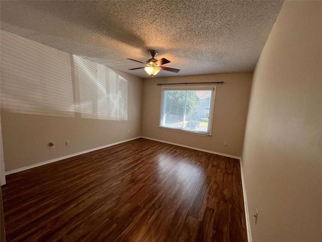 spare room with a textured ceiling, dark hardwood / wood-style floors, and ceiling fan