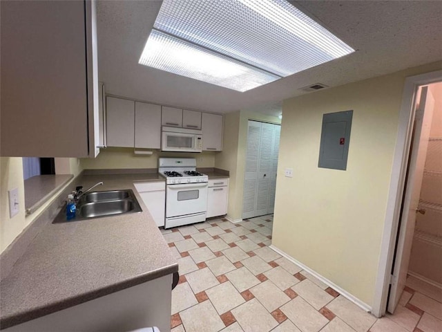 kitchen with electric panel, sink, and white appliances