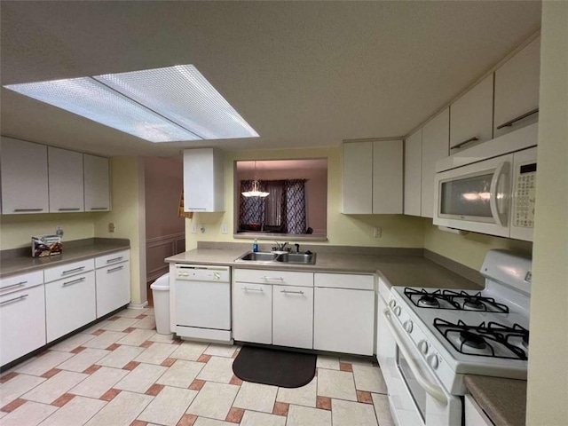 kitchen featuring white appliances, sink, and white cabinets