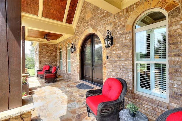 property entrance with a porch and brick siding