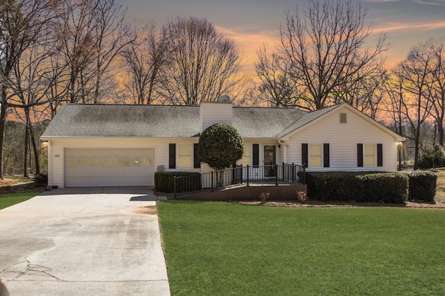 ranch-style house with a garage, roof with shingles, driveway, and a chimney