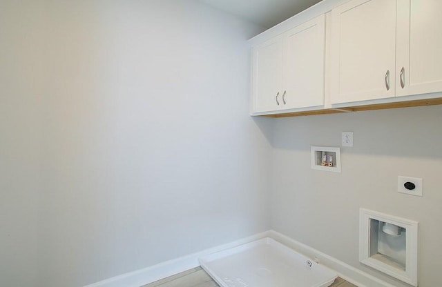 washroom with washer hookup, electric dryer hookup, hookup for a gas dryer, and cabinets