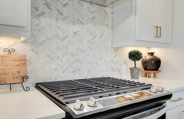 kitchen featuring white cabinetry, extractor fan, and tasteful backsplash