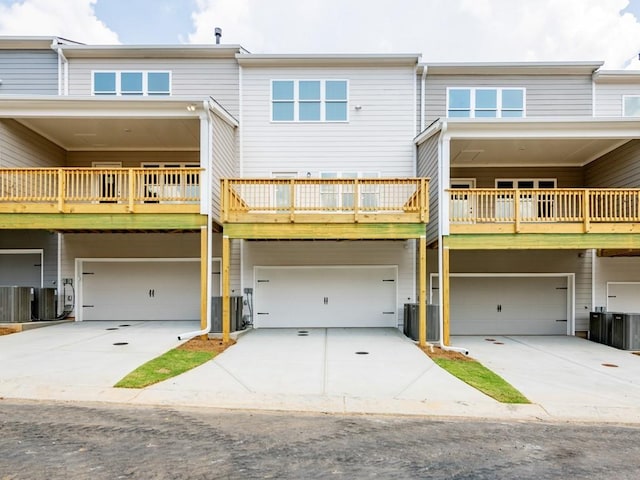 view of front of house featuring a garage and central AC unit