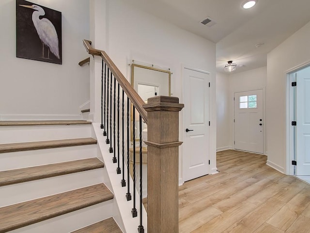 stairs with hardwood / wood-style floors