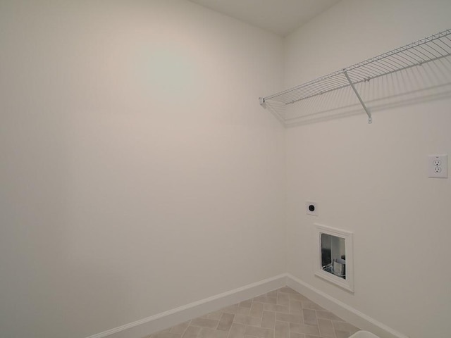 clothes washing area featuring hookup for an electric dryer and light tile patterned floors