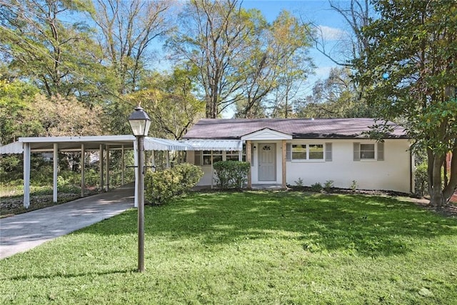 view of front of property with a front yard and a carport