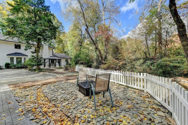 view of patio with a fire pit and a gazebo